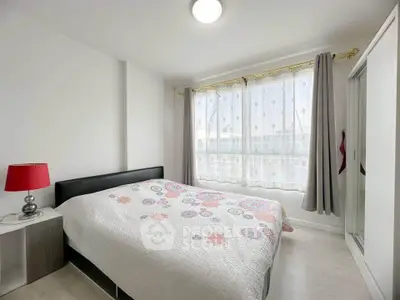 Bright and cozy bedroom with modern decor and large window for natural light