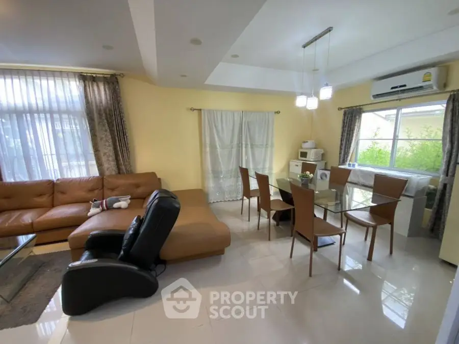 Spacious living room with modern furniture and large windows for natural light.