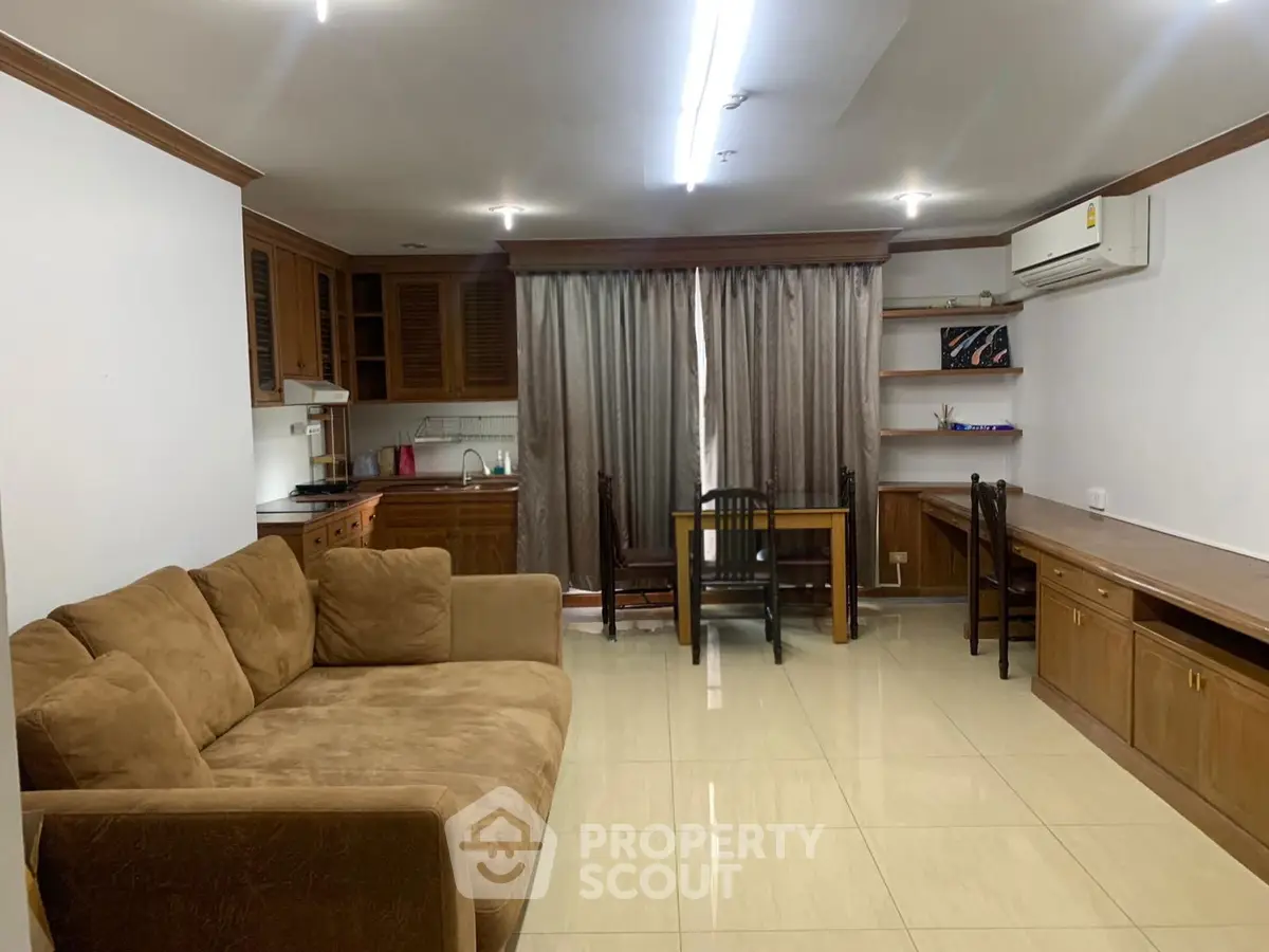 Spacious living room with cozy sofa and dining area in modern apartment