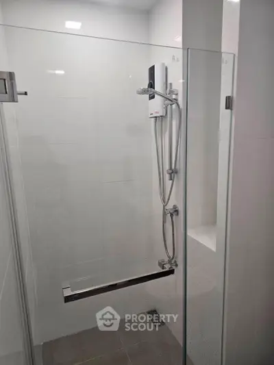 Modern bathroom with glass shower enclosure and sleek fixtures
