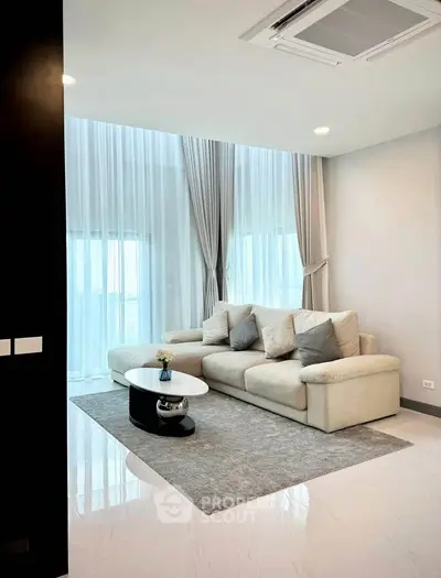 Luxurious modern living room with high ceilings and elegant decor