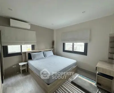 Spacious modern bedroom with natural light and stylish decor