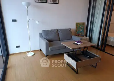 Modern living room with stylish sofa and adjustable coffee table in a cozy apartment.