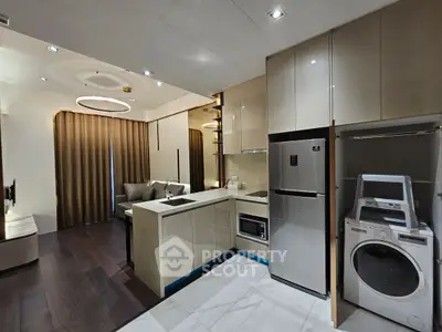Modern open-layout kitchen with sleek appliances and cozy living area, perfect for urban living.
