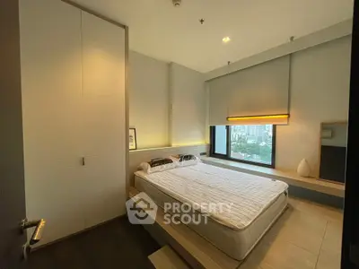Modern bedroom with city view, featuring sleek design and cozy ambiance.