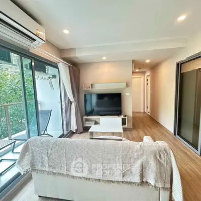 Modern living room with balcony access and stylish decor