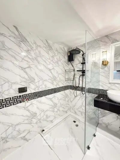 Luxurious marble bathroom with modern shower and elegant fixtures