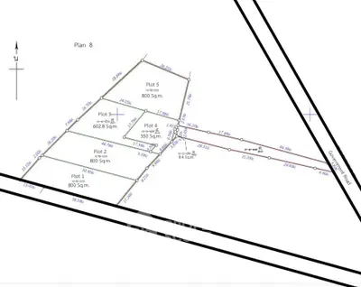 Detailed schematic plan of multiple real estate plots with measurements and layout.