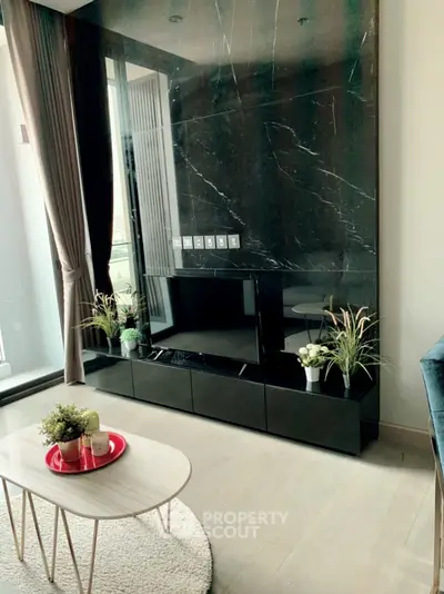 Modern living room with sleek black marble wall and stylish decor