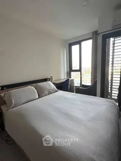 Modern bedroom with large windows and stylish furniture