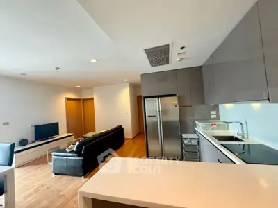 Modern open-layout living room with sleek kitchen and stylish furniture
