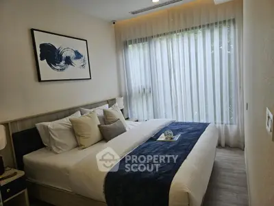 Modern bedroom with large window and stylish decor in a cozy apartment