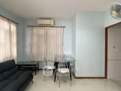 Cozy living room with modern furniture and air conditioning in a bright apartment.