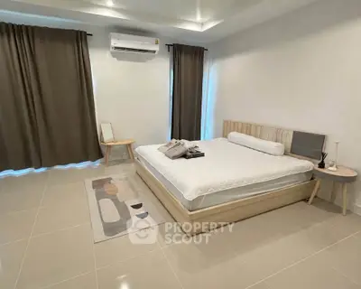 Spacious modern bedroom with minimalist decor and natural light