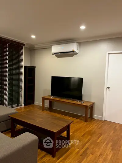 Cozy living room with modern TV setup and air conditioning