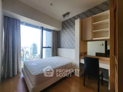 Modern bedroom with city view, featuring stylish decor and ample natural light, perfect for urban living.