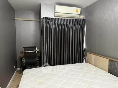 Modern bedroom with sleek design, featuring a comfortable bed and a compact study area.