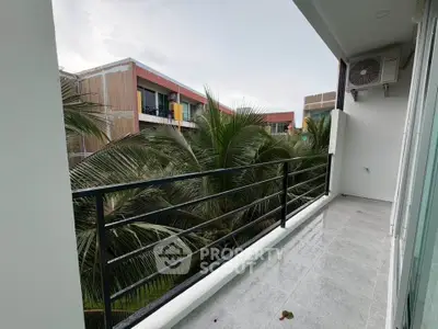 Modern balcony with lush greenery and contemporary building view