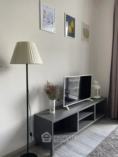 Modern living room with stylish decor and flat-screen TV on sleek console
