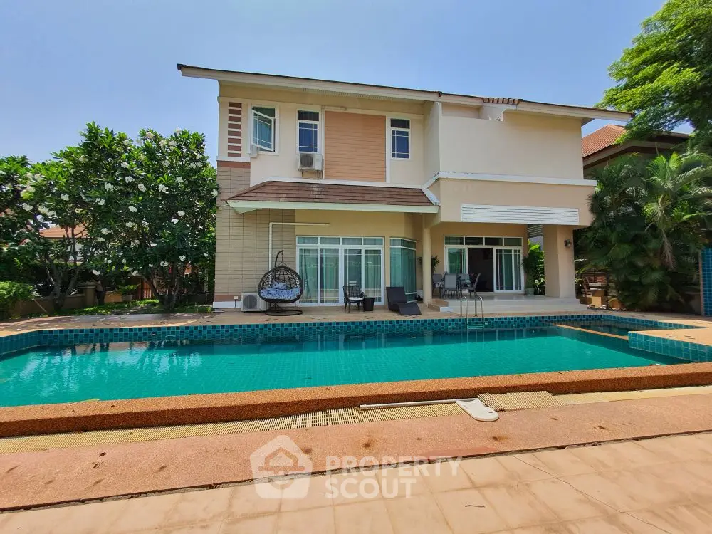 Luxurious two-story home with private pool and lush greenery