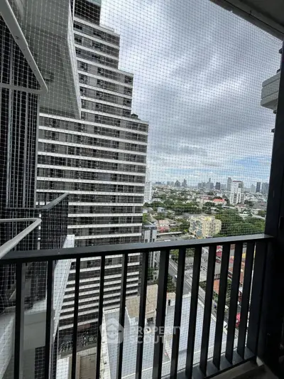 Stunning cityscape view from a high-rise balcony with modern railing design.