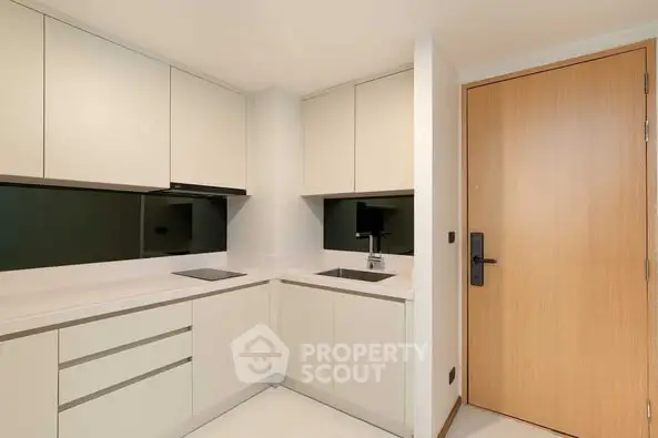 Modern minimalist kitchen with sleek cabinetry and integrated appliances