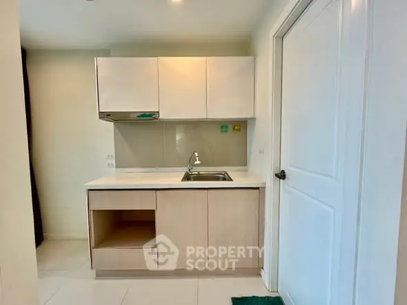 Modern compact kitchen with sleek cabinetry and stainless steel sink