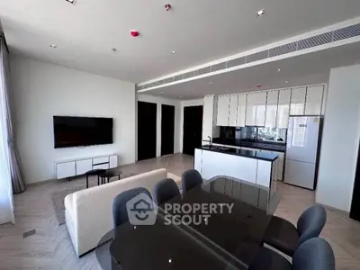 Modern open-plan living and dining area with sleek kitchen design