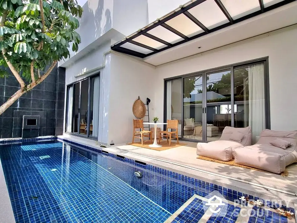 Luxurious modern villa with private pool and stylish outdoor seating area