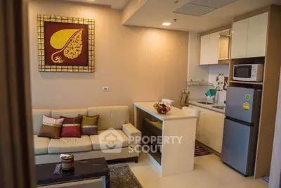 Modern living room with cozy sofa and compact kitchen in open layout apartment