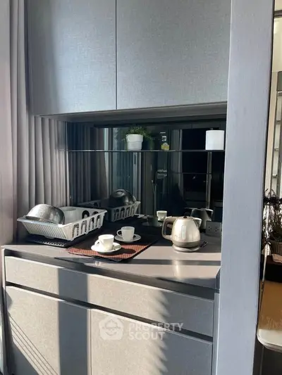 Modern kitchen nook with sleek cabinetry and appliances, perfect for compact living spaces.