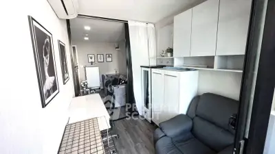 Modern compact living room with stylish decor and efficient storage solutions.