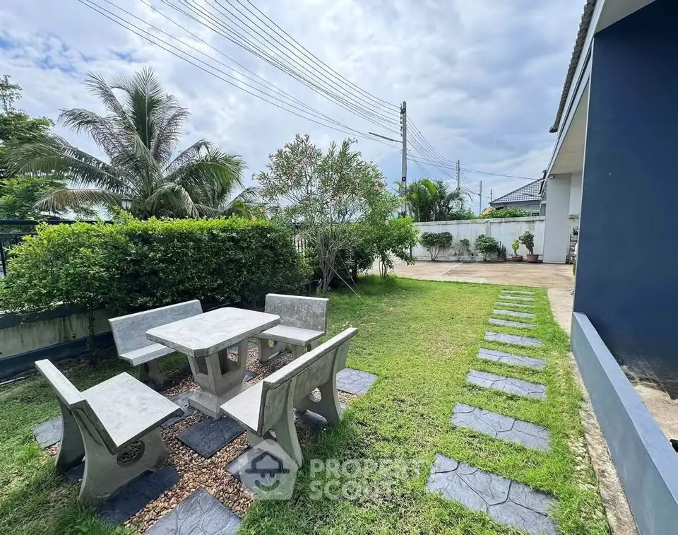 Charming garden area with stone table set in a suburban home exterior
