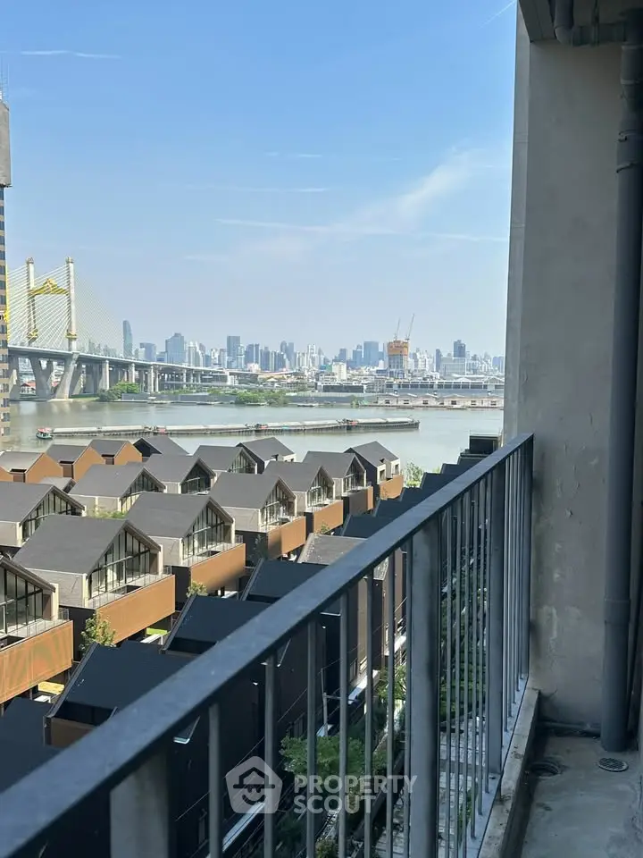 Stunning cityscape view from a modern balcony overlooking river and skyline, perfect for urban living.