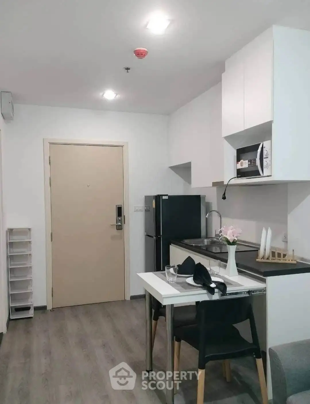 Modern compact kitchen with dining area in stylish apartment