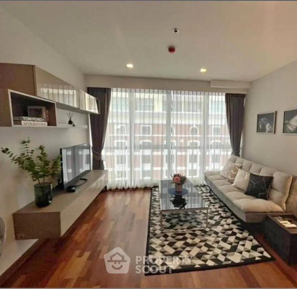 Modern living room with stylish decor and large window for natural light.