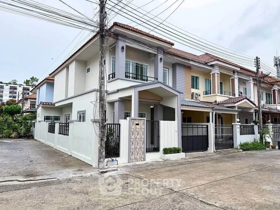 Charming two-story townhouse with modern facade and gated entrance in a serene neighborhood.