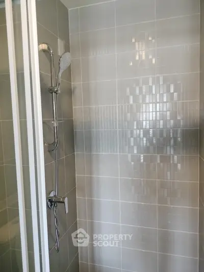 Modern bathroom shower with sleek tile design and chrome fixtures