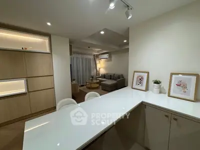 Modern open-layout living room with stylish decor and cozy seating area.