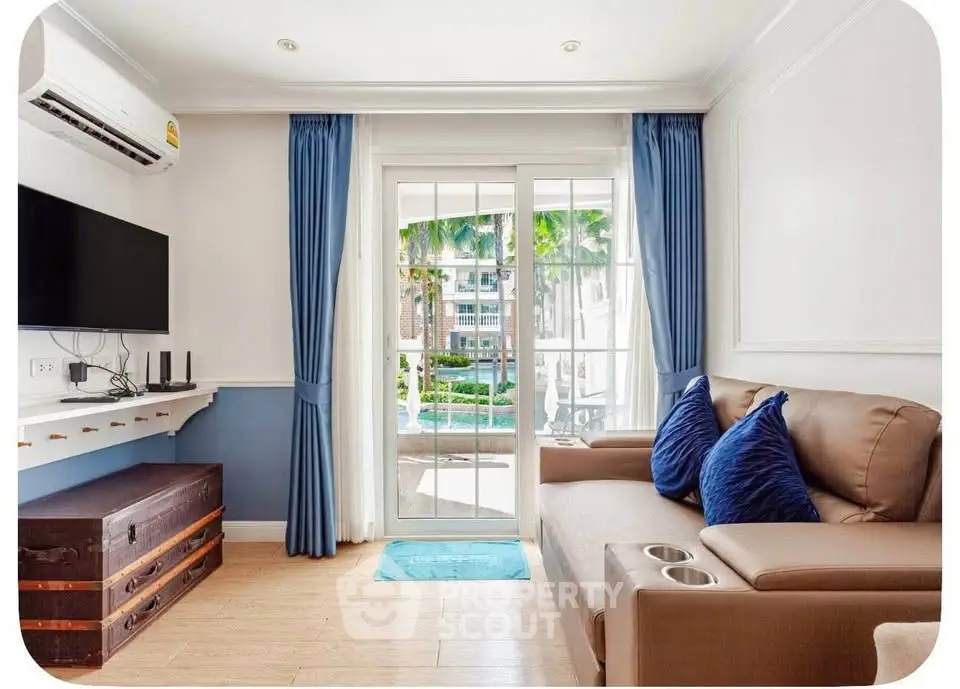 Charming living room with pool view, elegant decor, and cozy seating in a modern apartment.