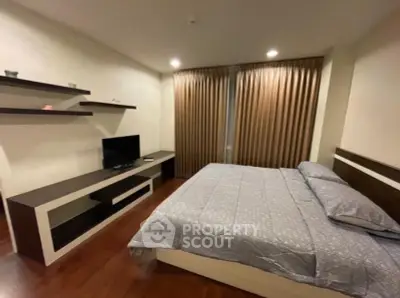 Spacious bedroom with modern decor and ample natural light