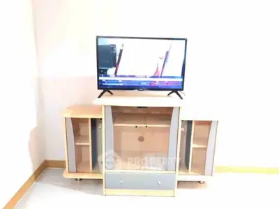Modern living room with sleek TV stand and flat-screen television, perfect for entertainment setup.