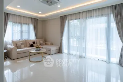 Spacious modern living room with elegant decor and large windows for natural light.
