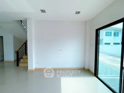 Bright modern interior with large windows and staircase, ideal for customization.