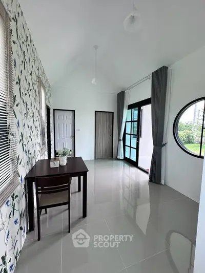 Spacious modern room with elegant decor and large windows