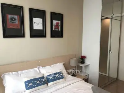 Stylish bedroom with modern decor and mirrored wardrobe in a cozy apartment.