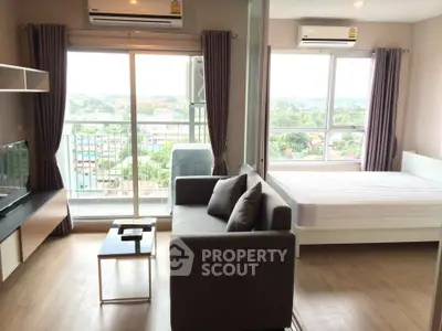Modern studio apartment with balcony and scenic view, featuring air conditioning and stylish furnishings.