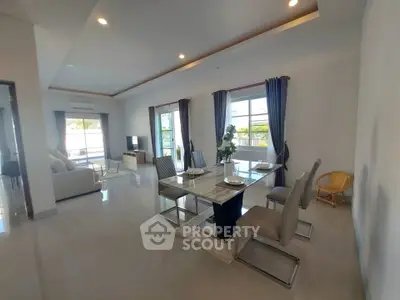 Spacious modern living and dining area with elegant decor and ample natural light.