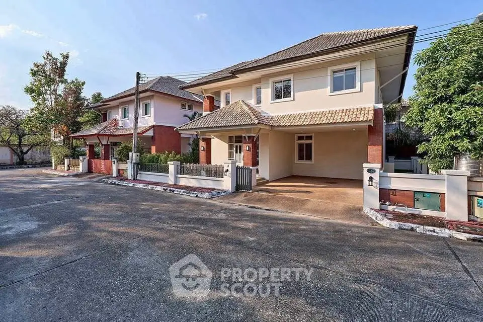 Charming suburban house with spacious driveway and lush greenery, perfect for family living.