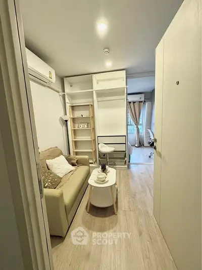 Cozy living room with modern decor and natural light, perfect for relaxation and comfort.